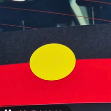 Load image into Gallery viewer, Flag with a yellow circle on a black and red background, placed on a reflective surface.