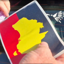 Load image into Gallery viewer, Person holding a card with a yellow silhouette on a red and blue background