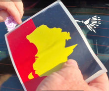 Load image into Gallery viewer, Person holding a card with a yellow silhouette on a red and blue background