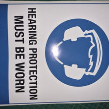 Load image into Gallery viewer, Sign with a helmet icon and text 'Hearing protection must be worn' on a white background with blue border.
