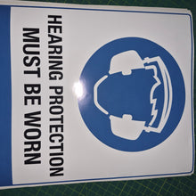 Load image into Gallery viewer, Sign with hearing protection symbol and text on a green cutting mat