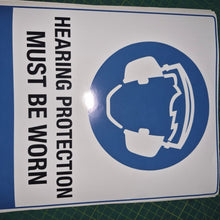 Load image into Gallery viewer, Sign with hearing protection symbol and text on a green cutting mat