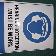Load image into Gallery viewer, Adhesive vinyl Sign with a hearing protection symbol and text on a cutting mat