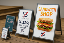 Load image into Gallery viewer, Set of sandwich shop signs with branding and promotional text on a wooden surface.