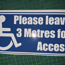 Load image into Gallery viewer, Blue sign with white text and wheelchair icon on a green cutting mat
