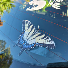Load image into Gallery viewer, Butterfly decal on a car window with trees in the background