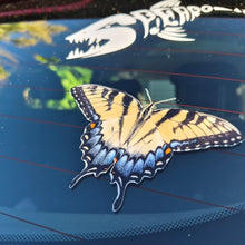 Load image into Gallery viewer, Butterfly on a car windshield with a dragon design in the background