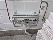 Load image into Gallery viewer, Metal stand with wire mesh top against a tiled wall