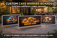 Load image into Gallery viewer, Custom café barrier boards with branding and product images in front of a café.
