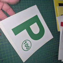 Load image into Gallery viewer, Green 'P' with a number on a white card held over a green cutting mat.