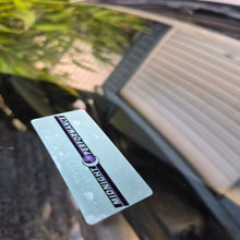 Load image into Gallery viewer, Decal with 'Midnight Performance' logo on a car Service due seen from the outside of the car