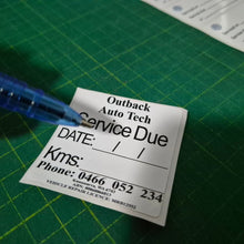 Load image into Gallery viewer, Double-sided service due decal showing reverse side with service date and contact information for mechanics