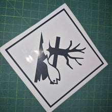 Load image into Gallery viewer, Sticker with a black silhouette of a tree, bird, and lightning bolt on a white background, placed on a green cutting mat.