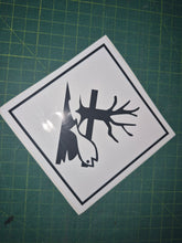 Load image into Gallery viewer, Sticker with a black silhouette of a tree, bird, and lightning bolt on a white background, placed on a green cutting mat.