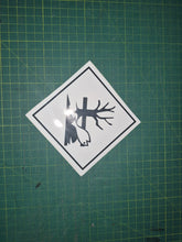 Load image into Gallery viewer, Sticker of a fish with a tree and log on a green cutting mat