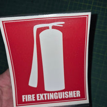 Load image into Gallery viewer, Fire extinguisher sign held by a hand on a dark grid background