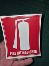 Load image into Gallery viewer, Fire extinguisher sign held by a hand on a dark grid background