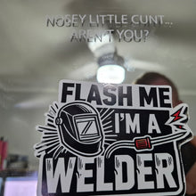 Load image into Gallery viewer, Sticker with text 'Flash me I'm a welder' held up to a mirror with offensive text.