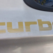 Load image into Gallery viewer, Gold 'turbo' decal on a car's white surface