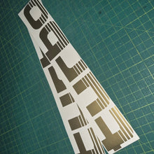 Load image into Gallery viewer, Turbo decal on a green cutting mat with grid lines