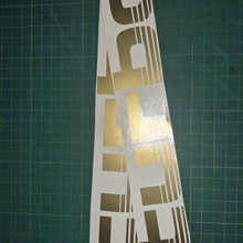 Load image into Gallery viewer, Set of 'Turbo' decals on a green cutting mat with grid lines