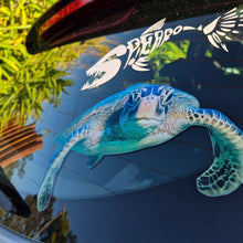 Load image into Gallery viewer, Car window with a sea turtle decal and another decal of a bird.