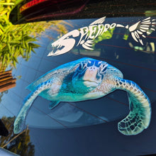 Load image into Gallery viewer, Car window with a turtle decal and reflective smooth window surface.