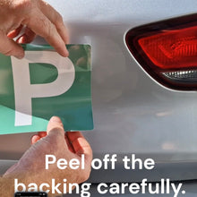 Load image into Gallery viewer, Person peeling a green and white 'P' plate from a car, with text instructing to peel off the backing carefully.