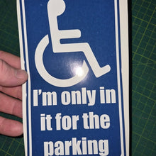 Load image into Gallery viewer, Handheld blue and white sign with wheelchair icon and text on a green cutting mat.