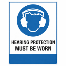 Load image into Gallery viewer, Sign with a blue circle featuring a white icon of ear protectors and text 'HEARING PROTECTION MUST BE WORN' on a white background.