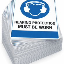Load image into Gallery viewer, Stack of 'Hearing protection must be worn' signs with a blue and white design.