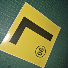 Load image into Gallery viewer, Yellow square with a black 'L' and a black circle with number 90 on a green grid background