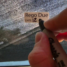 Load image into Gallery viewer, Hand holding a marker with 'Rego Due' text over a textured surface
