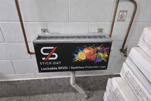 Load image into Gallery viewer, Lockable RPZD/backflow protection cage with Stick-Dat branding on a tiled wall.