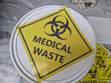 Load image into Gallery viewer, Yellow 'Medical Waste' sign with biohazard symbol on a white container lid.