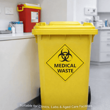 Load image into Gallery viewer, Yellow medical waste bin in a clinical setting with biohazard symbol