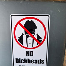 Load image into Gallery viewer, Sign with a humorous 'No Dickheads Allowed!' Sticker on a chalkboard background
