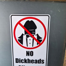 Load image into Gallery viewer, Sign with a humorous 'No Dickheads Allowed!' Sticker on a chalkboard background