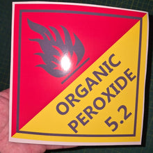 Load image into Gallery viewer, Organic Peroxide 5.2 Sticker with a red and yellow warning triangle and text on a cutting mat.