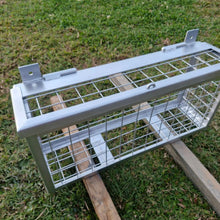 Load image into Gallery viewer, Metal Plumbers cage Drying on a wooden stand with grass in the background
