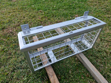 Load image into Gallery viewer, Metal Plumbers cage Drying on a wooden stand with grass in the background