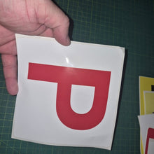 Load image into Gallery viewer, Hand holding a red 'P' on a white background against a green cutting mat.