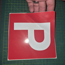 Load image into Gallery viewer, Red square sign with a white 'P' held by a hand on a green cutting mat.