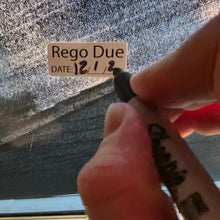 Load image into Gallery viewer, Hand holding a marker near a 'Rego Due' sign on a textured surface