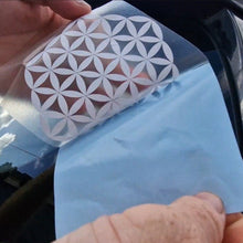 Load image into Gallery viewer, Person holding a car window decal with a geometric design