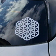 Load image into Gallery viewer, White geometric decal on a car window with a cloudy sky reflection.