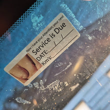 Load image into Gallery viewer, Close-up of a label on a blue surface with text and a foot image.