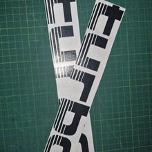 Load image into Gallery viewer, Two black and white decals with 'TURBO' text on a green cutting mat.