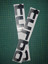 Load image into Gallery viewer, Two black and white decals with 'TURBO' text on a green cutting mat.