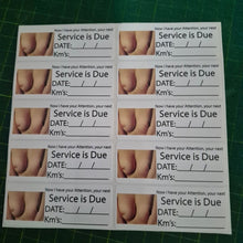 Load image into Gallery viewer, Sheet of printed labels with 'Service is Due' text and images on a green cutting mat.